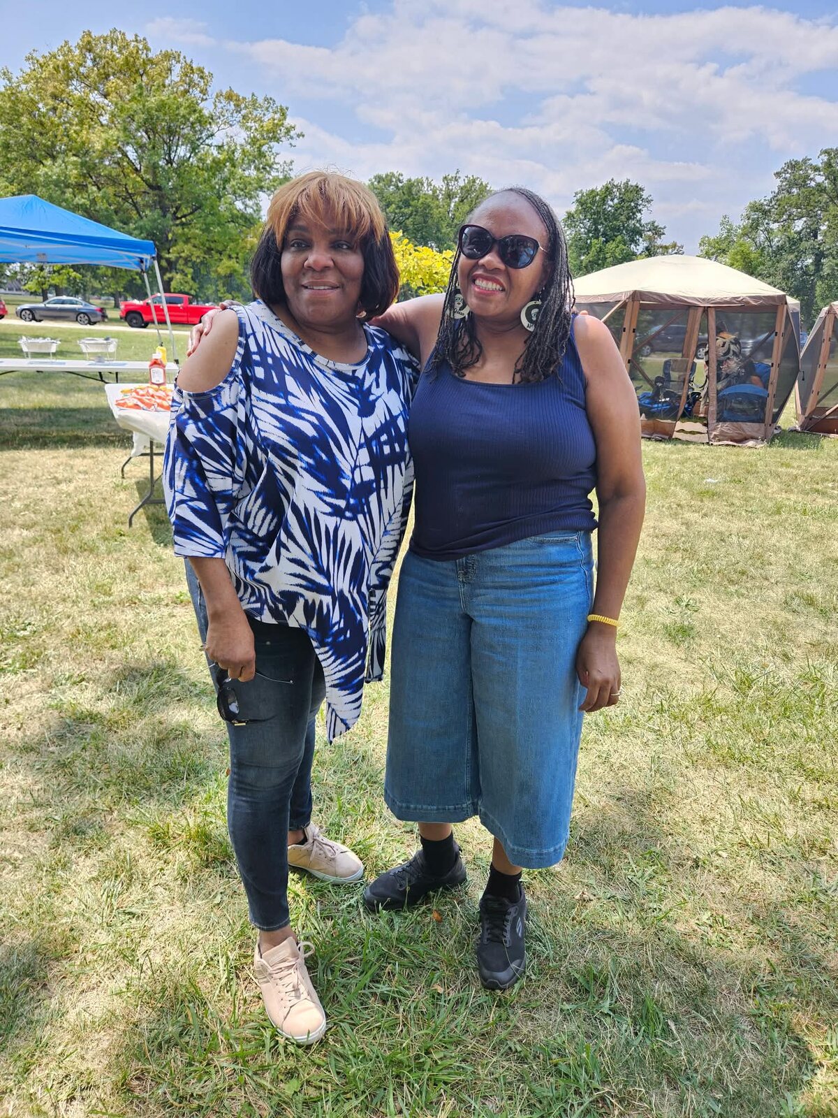 Two family members smiling together in the park